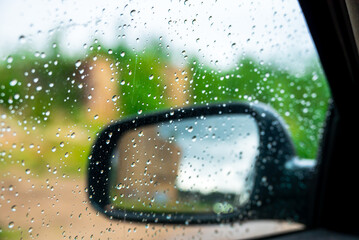 Raindrops on the side window of a car. Small depth of field.