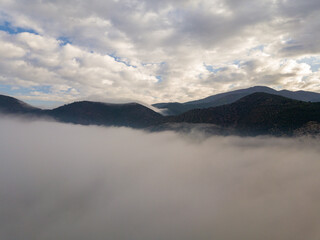 Aerial view of a mountain in the fog, Tuscany, Italy.