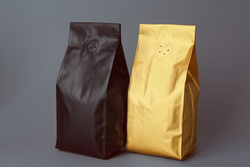 Different blank foil packages on grey background