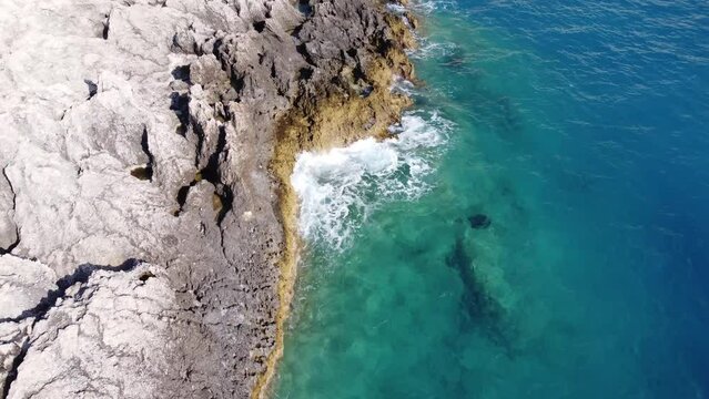 Aerial view of sea hitting the rocks on Porto Katsiki beach. Tropical turquoise sea in summer season on Lefkada island.