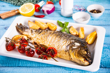 Fresh tasty raw seafood fish served on old blue wooden table with cooking ingredients. Top view. Copy space.