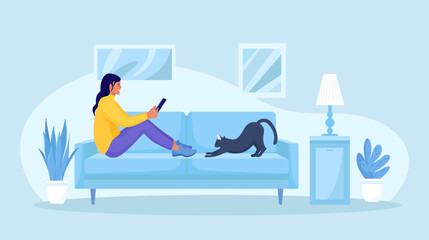 Young girl using tablet pc or phone, lying on sofa at home and reading news. Woman running remotely on freelance. Surfing on the internet, shopping online or social media communication