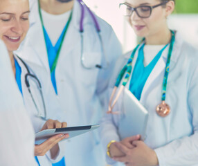 Doctor showing something in his tablet to his medical team