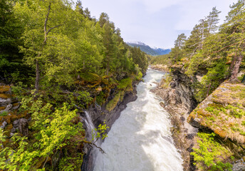 Fototapeta na wymiar Slettafossen, a waterfall in the Rauma river, a little south of Verma (upstream) in Romsdalen in Møre og Romsdal.
