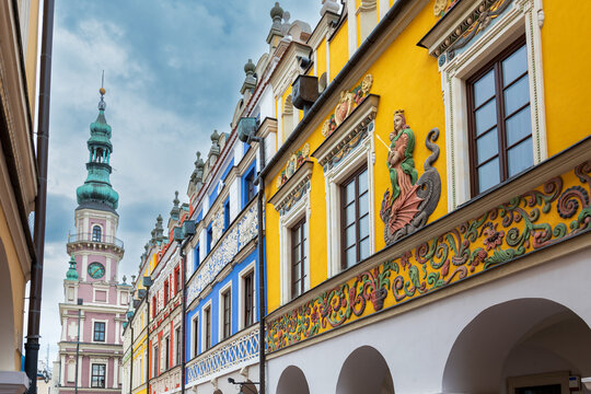 Armenian tenement houses on the market square in Zamość. Beautiful colorful buildings front view. .Town hall in the background. Zamość, Poland