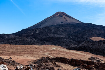 Hiking trail over volcanic desert terrain leading to summit of volcano Pico del Teide from Pico...