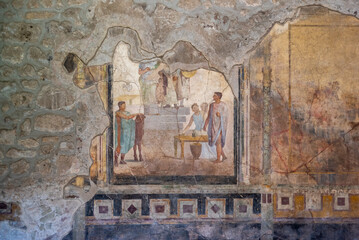 POMPEII, ITALY - MAY 04, 2022 - Scenic painting of Roman inhabitants in a fresco of an ancient...