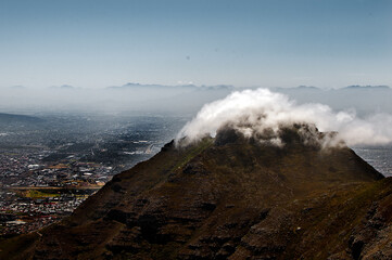 Fluffy cloud covering a mountain top