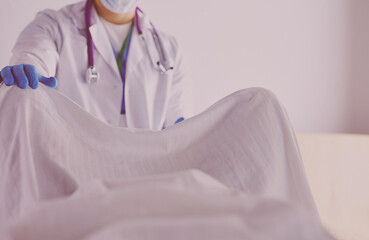 male obstetrician and scrubs nurse are delivered to the pregnant woman in the delivery room of the hospital