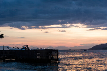Naklejka premium Sunset in a beach near the town of Angra dos Reis, State of Rio de Janeiro, Brazil. Taken with Nikon D7100 18-200 lens, at 52mm, 1/40 f 4.8 ISO 100. Date: Feb 09, 2016