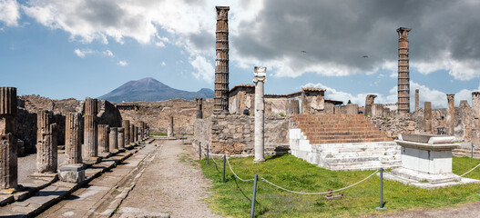 POMPEII, ITALY - MAY 04, 2022 - Colonnade and sculptures of the Temple of Apollo near the Pompeian forum, Italy