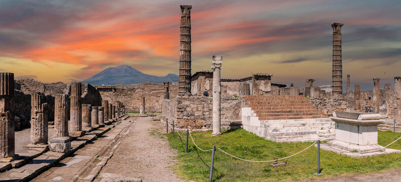 POMPEII, ITALY - MAY 04, 2022 - Colonnade and sculptures of the Temple of Apollo near the Pompeian forum, Italy