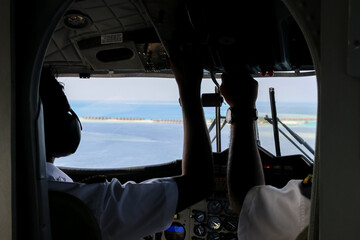 Fototapeta premium pilots in cockpit of airplane
