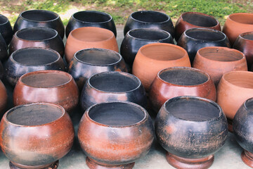 Begging bowls of Buddhist monks in a temple in Thailand
