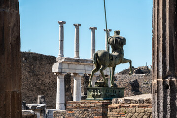POMPEII, ITALY - MAY 04, 2022 - Beautiful statue of an ancient lancer on the forum of the ancient...