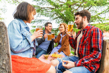 Diverse people friends haging drinking beer outside – happy friends drinking beer at rooftop home...