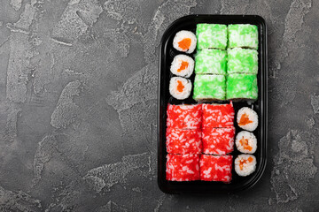 Assorted sushi. Big set of sushi. A variety of Japanese sushi with crab, salmon, eel and caviar on a black marble table. Top viewCopy space. food delivery