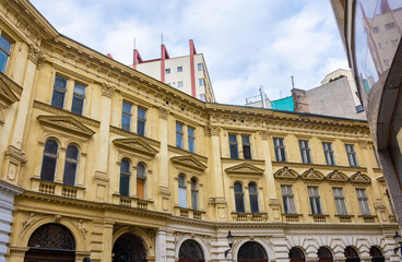 Fototapeta na wymiar Yellow facade of a palace in the historic center of Bratislava, Slovakia