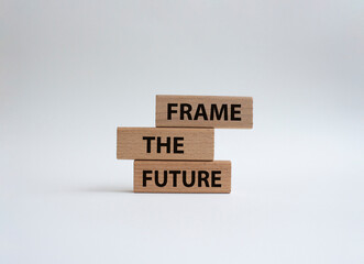 Frame the future symbol. Wooden blocks with words Frame the future. Beautiful white background....