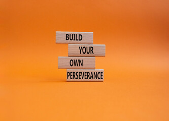 Perseverance symbol. Wooden blocks with words Build your own Perseverance. Beautiful orange background. Business and 'Build your own Perseverance' concept. Copy space.