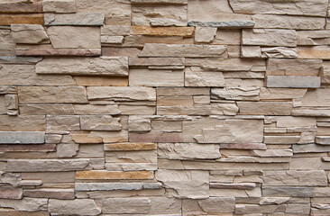 Pattern of decorative brown slate stone wall surface.