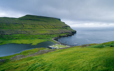 View of an old soccer field with a picturesque cliff on the coast near the village of Eidi in the...