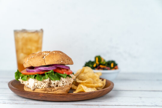 Deli sandwich with drink on a light surface