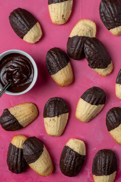 Madeleine cookies dipped in melted chocolate 