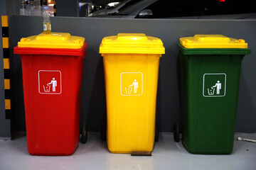 yellow, green, blue and red recycling bins in public places