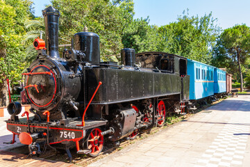 Fototapeta na wymiar Kalamata, Greece, July 21, 2022. Old train in the Municipal Railway Park of Kalamata.
