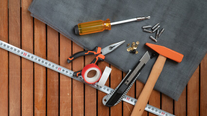 Tool kit on wooden background screwdriver, hammer, wire cutters