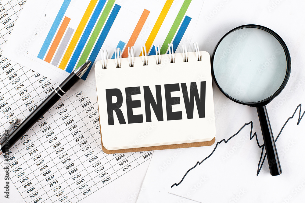Poster renew text on notebook on the graph background with pen and magnifier