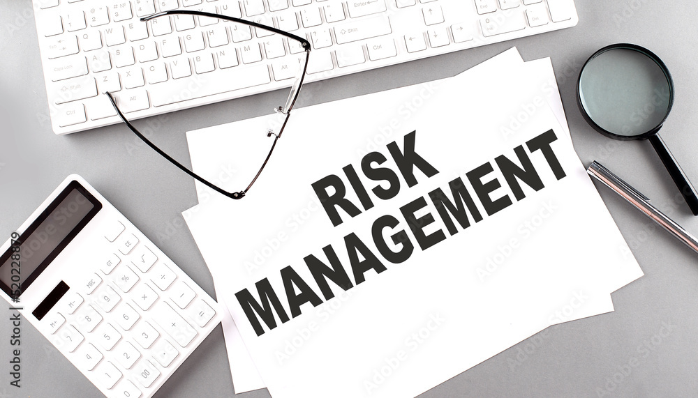 Poster risk management text on paper with keyboard, calculator on grey background