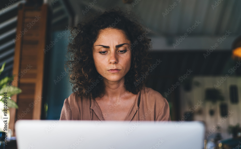 Aufkleber young female programmer puzzled on received online information using laptop computer for working rem