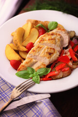delicious grilled chicken breast served with grilled vegetables