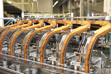 Large biscuit factory. A line of biscuits in a large factory. Packing crackers on the machine. Innovative production.