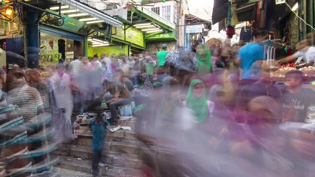 The colorful souk in the old city of Jerusalem Israel timelapse. Crowd of people passing by on this makret. Selling fruits and vegetables