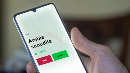 Un investisseur analyse un fonds etf arabie saoudite sur un graphique. Un téléphone affiche le cours de l'ETF. Texte en français francais Arabie saoudite