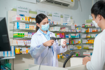 Portrait of female pharmacist wearing face mask in a modern pharmacy drugstore.