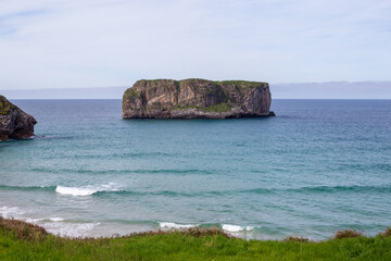 Northern Spain beach, beautiful sea, next to cliffs and rocks on the shore