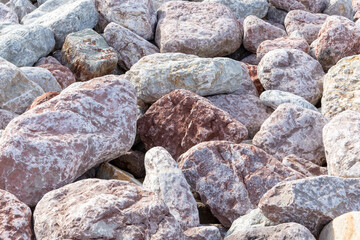 pinkish and gray rocks on a beach in northern spain