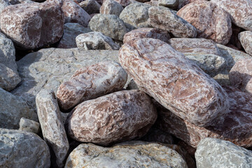 pinkish and gray rocks on a beach in northern spain
