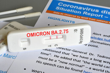 SARS‑CoV‑2 antigen test kit for self testing with positive result and text OMICRON BA.2.75 on paper documents. Concept for new variant "Centaurus"