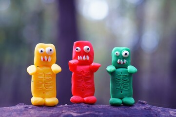 Figures of colorful zombies in close-up. Funny toy monsters made of plasticine.