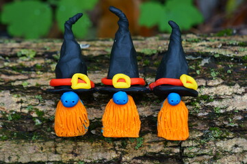 Three dwarfs in a festive hat and a red beard. Halloween decorations.