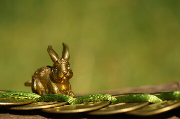 Rabbit figurine with Chinese coins. A religious symbol. Feng shui figurines.