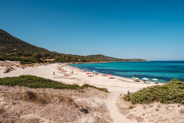 Holidaymakers enjoy the turquoise Mediterranean sea at Bodri beach in the Balagne region of Corsica