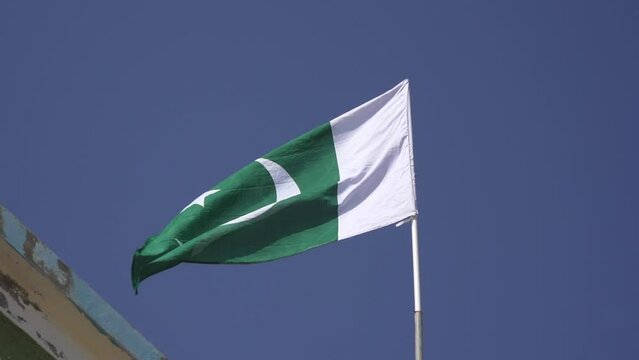 Pakistan flag waving. Recorded in slow motion. Green and white