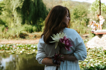 woman with bucket lotus flowers 