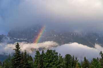 Colorful rainbow in the mountains above Canmore, Alberta in the Canadian Rockies on a summer morning
